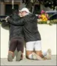  ?? RINGO H.W. CHIU - THE AP ?? People place flowers near the scene of a mass shooting Thursday in Thousand Oaks, Calif., after a gunman opened fire Wednesday evening inside a country music bar, killing multiple people including a responding sheriff’s sergeant.