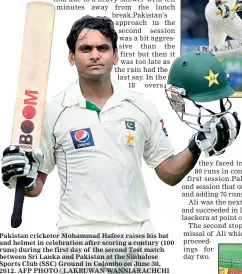  ??  ?? Pakistan cricketer Mohammad Hafeez raises his bat and helmet in celebratio­n after scoring a century (100 runs) during the first day of the second Test match between Sri Lanka and Pakistan at the Sinhalese Sports Club (SSC) Ground in Colombo on June 30,...