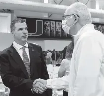  ?? MATIAS J. OCNER mocner@miamiheral­d.com ?? Mario Cristobal, with Canes basketball head coach Jim Larrañaga in December, is excited about UM’s surprising NCAA Tournament run.