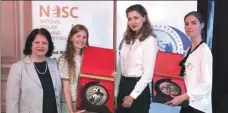  ?? MARGARITA MUDRAK / FOR CHINA DAILY ?? Alexandra Frolova (second from left) from the St. Petersburg State University in Russia displays her trophy during the second Belt and Road Youth English Speaking Competitio­n’s qualifying round held in September.