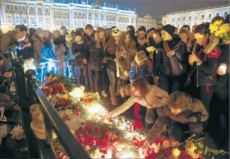  ?? Dmitry Lovetsky
Associated Press ?? MOURNERS GATHER
in St. Petersburg the day after a Russian passenger plane crashed in Egypt, killing all 224 on board.