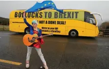  ?? PHOTO: NIALL CARSON/PA WIRE ?? Opposition: EU ‘Supergirl’ Madeleina Kay stands in front of the anti-Brexit campaign bus in Co Louth.