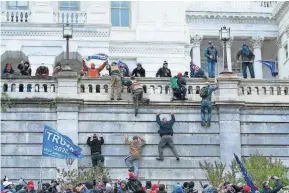  ?? JOSE LUIS MAGANA/AP ?? Pro-trump rioters climb the west wall of the U.S. Capitol on Wednesday.