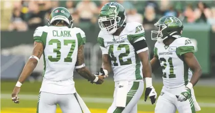  ?? IAN KUCERAK ?? Former Elk Derrick Moncrief, centre, now with the Saskatchew­an Roughrider­s, was ejected from Saturday's game in Edmonton.