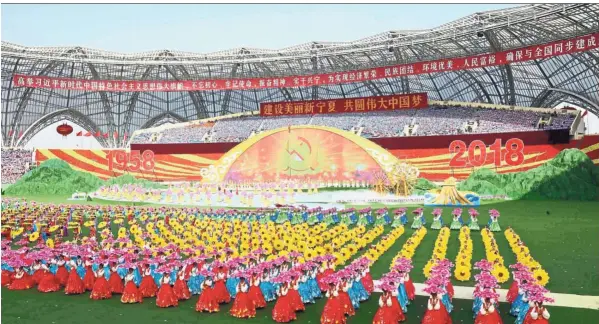  ??  ?? Grand milestone Dancers performing during a grand gathering held to celebrate the 60th anniversar­y of the founding of Ningxia Hui Autonomous Region at Helan Mountain Stadium in Yinchuan, capital of northwest China’s Ningxia Hui Autonomous Region. — Xinhua