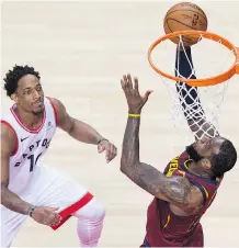  ?? TYLER ANDERSON ?? The Raptors’ DeMar DeRozan can only watch in vain as Cleveland star LeBron James gets an easy look at the basket during the Cavaliers’ 128-110 victory in Game 2 of their series in Toronto.