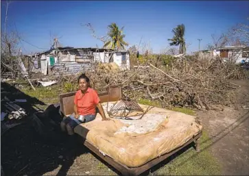  ?? Ramon Espinosa Associated Press ?? MARI CARMEN ZAMBRANO dries her bed Oct. 5 outside her home in La Coloma, Cuba, after Hurricane Ian tore off her roof. Cuba may be eligible for money from a soon-to-be-establishe­d loss-and-damage fund.