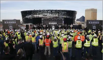  ?? STEVE MARCUS — LAS VEGAS SUN VIA AP ?? Las Vegas Raiders owner Mark Davis, center, speaks Wednesday during a news conference, officially renaming the team.