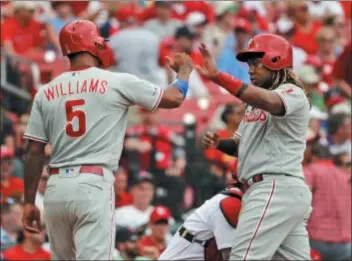  ?? JEFF ROBERSON — THE ASSOCIATED PRESS ?? Nick Williams, left, in more productive times, celebrates with Maikel Franco, right, after scoring on a Cesar Hernandez double against the Cardinals on May 8. Williams was optioned to Triple-A Lehigh Valley Sunday.