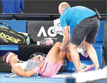  ?? WILLIAM WEST/AFP ?? Rafael Nadal receives medical attention during his men’s singles quarterfin­al match against Marin Cilic on day nine of the Australian Open in Melbourne yesterday.