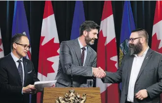  ?? DAVID BLOOM ?? Edmonton Mayor Don Iveson shakes hands with Municipal Affairs Minister Shaye Anderson, right, and Finance Minister Joe Ceci, left, during the announceme­nt of the City Charters Fiscal Framework Act at the Legislatur­e in Edmonton on Thursday.