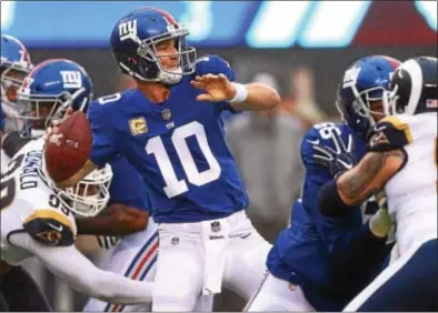  ?? JOHN BLAINE — FOR THE TRENTONIAN ?? Giants quarterbac­k Eli Manning throws the ball downfield during a game against the Los Angeles Rams last Sunday afternoon at MetLife Stadium.