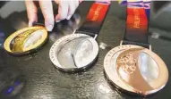  ??  ?? Glittering medals in gold, silver and bronze, crafted by Filipino artist Daniel dela Cruz, await winners of the 30th Southeast Asian Games which formally begins on Saturday at the Philippine Arena in Bocaue, Bulacan. (Alvin Kasiban)