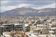  ?? Ammar Suleiman / AFP/Getty Images ?? The rebel-held neighborho­od of Jobar, on the eastern edge of the Syrian capital of Damascus, following a reported regime bombardmen­t, with Mount Qasioun in the background.