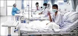  ?? ASSOCIATED PRESS ?? In this image made from video and released by the Thailand Government Spokesman Bureau, three of the 12 boys are seen recovering in their hospital beds after being rescued along with their coach from a flooded cave.