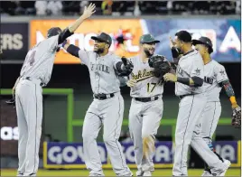  ?? Lynne Sladky ?? The Associated Press American League players Robinson Cano, second from left, and reliever Andrew Miler of the Cleveland Indians embrace after winning the All-star Game on Tuesday.