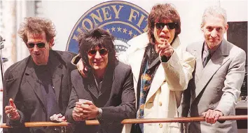  ?? TIMOTHY CLARE/GETTY IMAGES/FILES ?? Keith Richards, left, and Ronnie Wood (seen with Mick Jagger and Charlie Watts) have shared a long friendship, with Richards describing his bandmate as an “over-the-top man.”