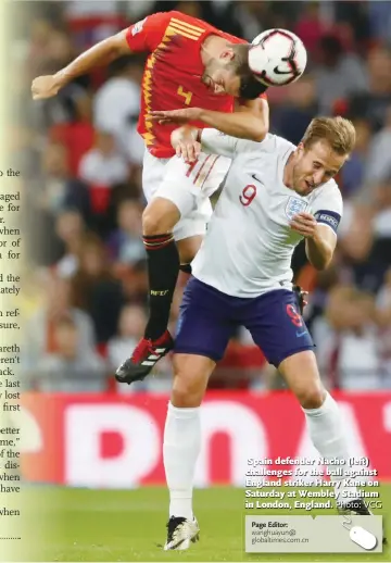  ?? Photo: VCG ?? Spain defender Nacho (left) challenges for the ball against England striker Harry Kane on Saturday at Wembley Stadium in London, England.