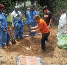  ?? SUBMITTED PHOTO — ANDREW KAHL/NATURE CONSERVANC­Y ?? W.B. Saul High School students create a brick channel for water in a new rain garden at the school in Roxborough June 7.