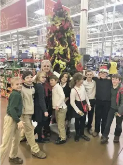  ?? COURTESY PHOTO ?? WCDS third graders shown with their teacher, Becky Ernest, as they buy toys to donate to Toys for Tots.