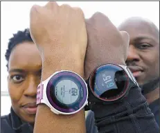  ??  ?? Democrat-Gazette file photo Pamela Royal and her husband, Kijana Royal, show off their fitness trackers. Having the right equipment and support system help people to keep their wellness goals.