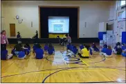  ?? PHOTO BY MELISSA SCHUMAN ?? Community school teacher Ms. Dobbs welcomes students to assembly on the first day of school.