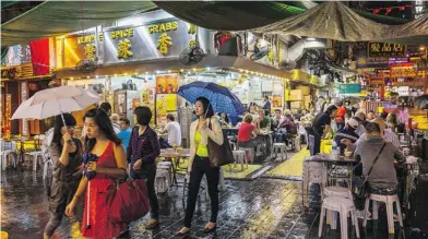  ??  ?? Colourful street markets offer an abundance of merchandis­e as well as places to eat.