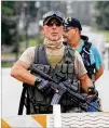  ?? JENNI GIRTMAN FOR THE AJC ?? Several armed militia groups converged on the city of Stone Mountain, forming columns and facing off against left-wing counter-demonstrat­ors.