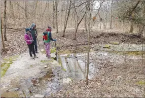  ?? ?? Carol Taylor (from left), Gene Williams and Karen Mowry look over a creek that bisects Big Sugar Creek State Park.