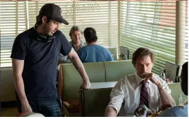  ??  ?? TABLe TALK Writer-director Jason Reitman on set with Jackman (above right).