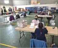  ?? PETE BANNAN - MEDIANEWS GROUP ?? Chester County elections staff handle mail-in ballots at the county operations center in Ehinger gymnasium on the campus of West Chester University.