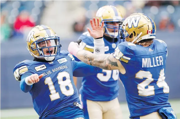  ?? — THE CANADIAN PRESS ?? Winnipeg’s Bryan Bennett, left, and Mike Miller celebrate a tackle against the Roughrider­s in the first half of Saturday’s game in Winnipeg. The Blue Bombers avoided a season-series sweep by the Riders, who had already secured a playoff spot.