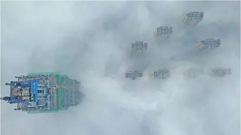  ??  ?? view shows the tops of highrise buildings poking out from heavy fog in Yangzhou, in China’s eastern Jiangsu province yesterday. Authoritie­s in the city issued a fog alert with heavy fog reducing visibility to 50 metres. — AFP photo