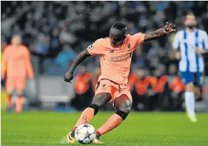  ?? Picture: AFP/FRANCISCO LEONG ?? HAT-TRICK MAN: Liverpool’s Senegalese midfielder Sadio Mane shoots to score their fifth goal, his third during the match against FC Porto