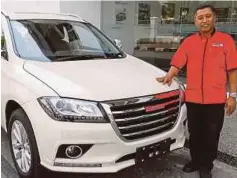  ??  ?? Go Auto Group of Companies CEO Ahmad Azam Sulaiman with a Haval
SUV.