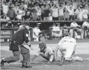  ?? JOE CAMPOREALE USA TODAY NETWORK ?? The Cubs’ Nico Hoerner beats a throw to Arizona’s Kevin Ginkel to score during the ninth inning at Chase Field.