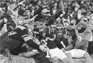  ?? Emilee Chinn / Associated Press ?? Bengals wide receiver Tyler Boyd, center, celebrates with teammates and fans after catching a touchdown pass in the second quarter. The Bengals’ offense scored on six drives, including Joe Burrow’s two TD passes.