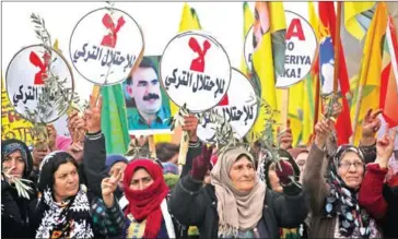  ?? DELIL SOULEIMAN/AFP ?? Syrian-Kurds march during a demonstrat­ion in the northeaste­rn Syrian city of Qamishli yesterday against the Turkish assault on the border enclave of Afrin.