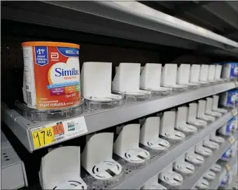  ?? AP FILE ?? ‘THIS IS A DILEMMA FOR FAMILIES’: Shelves typically stocked with baby formula sit mostly empty at a store in San Antonio Tuesday. Parents across the U.S. are scrambling to find baby formula because supply disruption­s and a massive safety recall have swept many leading brands off store shelves.