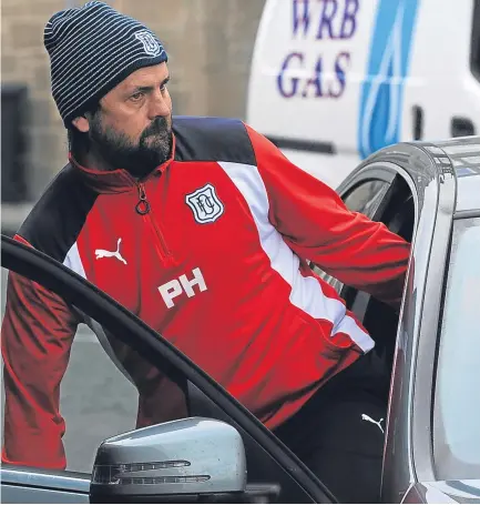  ??  ?? Paul Hartley prepares to leave Dens Park for the last time after being told his time was up at Dens Park.