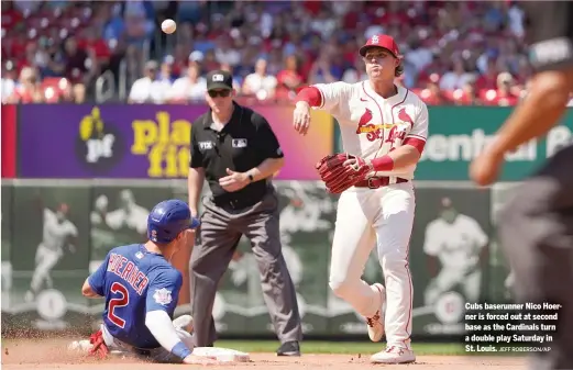  ?? JEFF ROBERSON/AP ?? Cubs baserunner Nico Hoerner is forced out at second base as the Cardinals turn a double play Saturday in St. Louis.