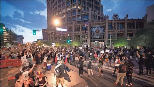  ?? ROB SCHUMACHER/THE REPUBLIC ?? Protesters march on Phoenix City Hall on May 30 to honor George Floyd, who died in the custody of Minneapoli­s police officers on May 25.