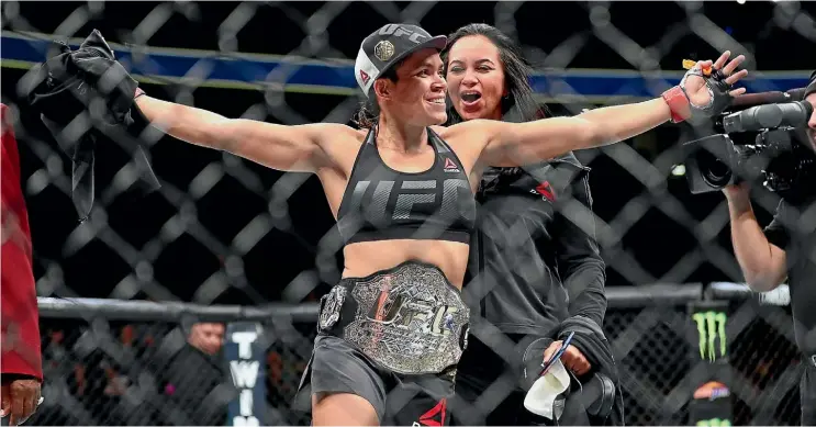  ??  ?? Amanda Nunes celebrates her win over Ronda Rousey at UFC 207.