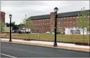  ?? NICHOLAS BUONANNO- NBUONANNO@TROYRECORD.COM ?? Workers get Canal Square Park ready for the first concert of the 2018Rock the Block Summer Concert series on Thursday evening in Cohoes.