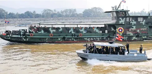  ?? TAWATCHAI KEMGUMNERD ?? Thai and Lao patrol boats ply the Mekong River in Chiang Saen district of Chiang Rai, in a joint operation to thwart drug traffickin­g. The joint effort is part of the “Safe Mekong” drug-bust campaign, being carried out by Thailand, Myanmar, Laos and...