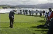  ?? ERIC RISBERG - THE ASSOCIATED PRESS ?? Clint Eastwood chips the ball to the 18th green during the celebrity challenge event of the AT&amp;T Pebble Beach National Pro-Am golf tournament on Feb. 6 in Pebble Beach, Calif.