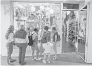  ?? Wilfredo Lee / Associated Press ?? Shoppers check out a store in Miami Beach. Retail sales increased 0.4 percent in April from March.