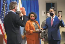  ?? Paul Kitagaki Jr. / Associated Press ?? Mia Bonta (center) assists as her husband, Rob Bonta, is sworn in as state attorney general by Gov. Gavin Newsom in April.