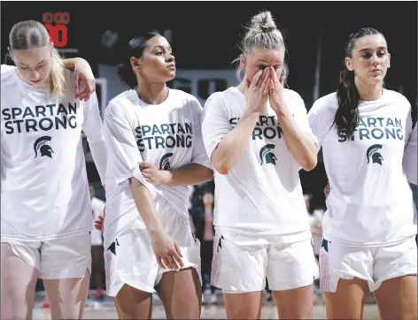  ?? AL GOLDIS/AP ?? MICHIGAN STATE PLAYERS including Stephanie Visscher (from left) Moira Joiner, Theryn Hallock and Abbey Kimball stand together before a game against Maryland on Saturday in East Lansing, Mich.