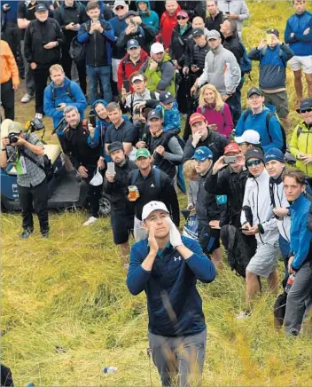  ?? Ben Stansall AFP/Getty Images ?? JORDAN SPIETH seeks guidance from a British Open rules official after getting himself into serious trouble on the 13th hole. He turned the dire situation into what may be the greatest moment of his career.